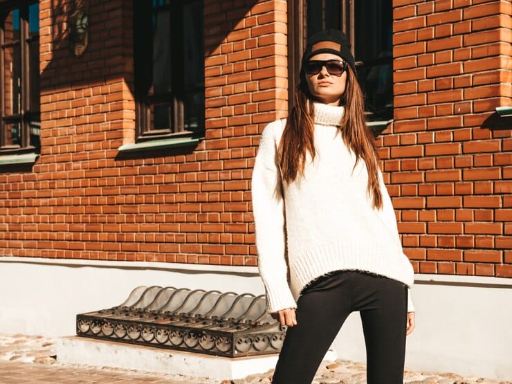 a woman in white high neck sweater with a black jean
